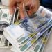 Philippine central bank signals peso intervention at 57 a dollar